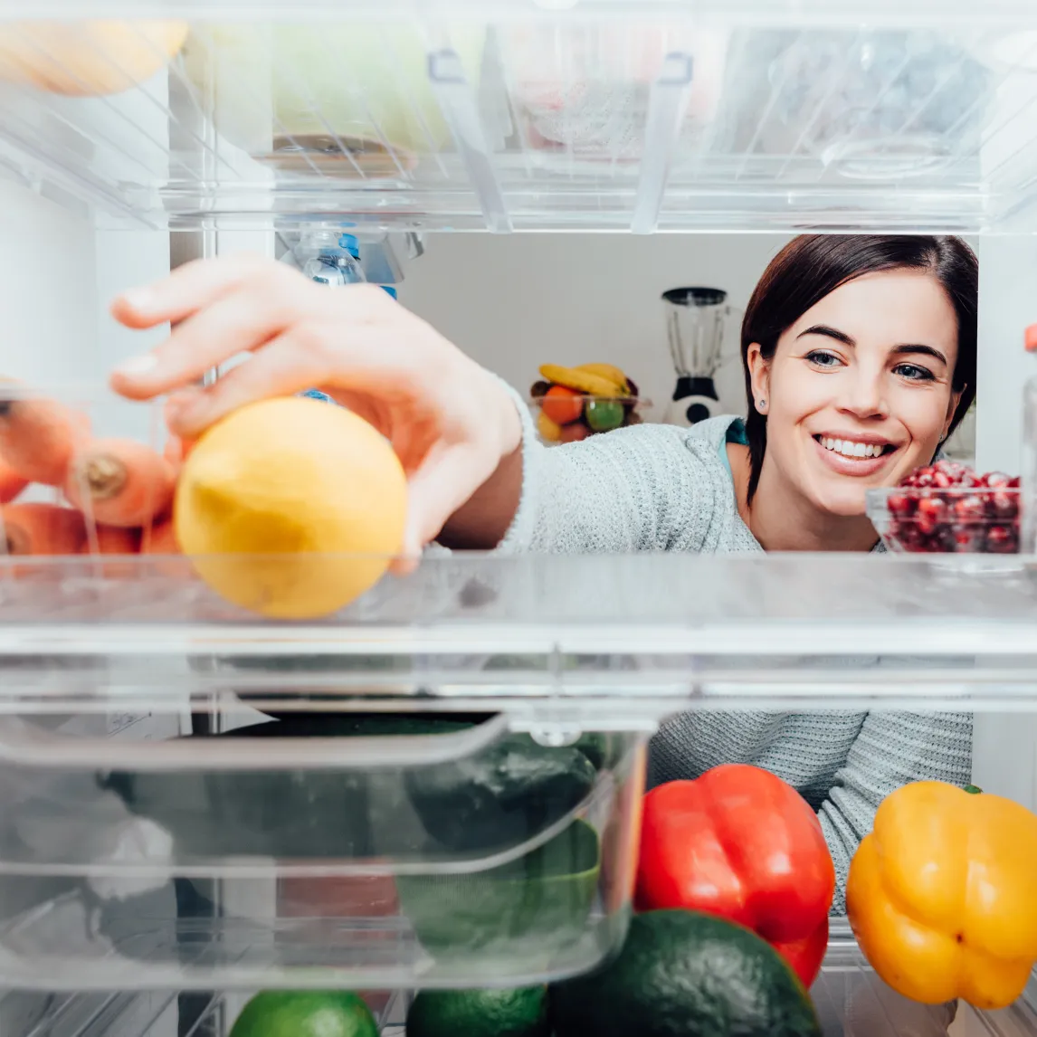 Woman taking food from the fridge